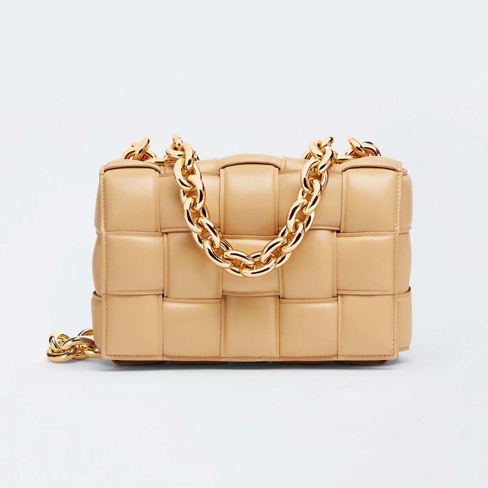 Front angle of Bottega Veneta Women Chain Cassette Padded Intrecciato Leather Crossbody Bag-Gold in red