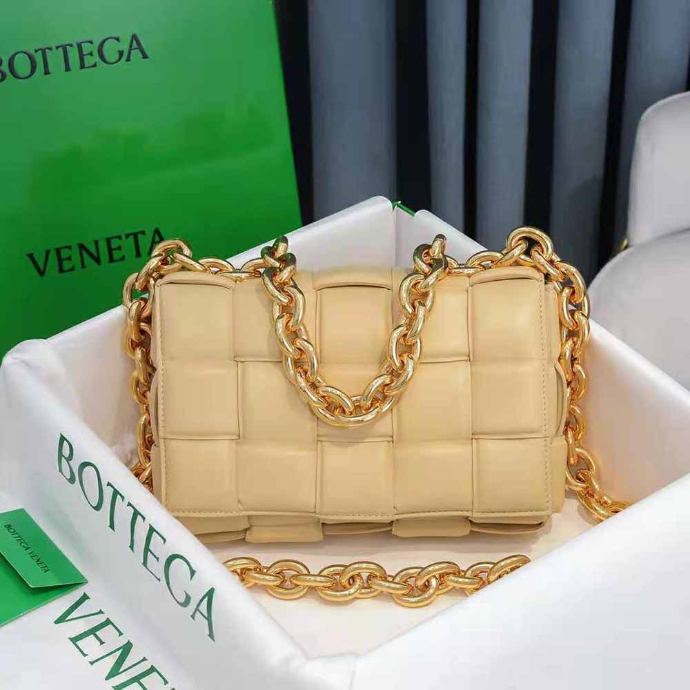 Close-up of gold chain strap and intrecciato leather on Bottega Veneta crossbody bag