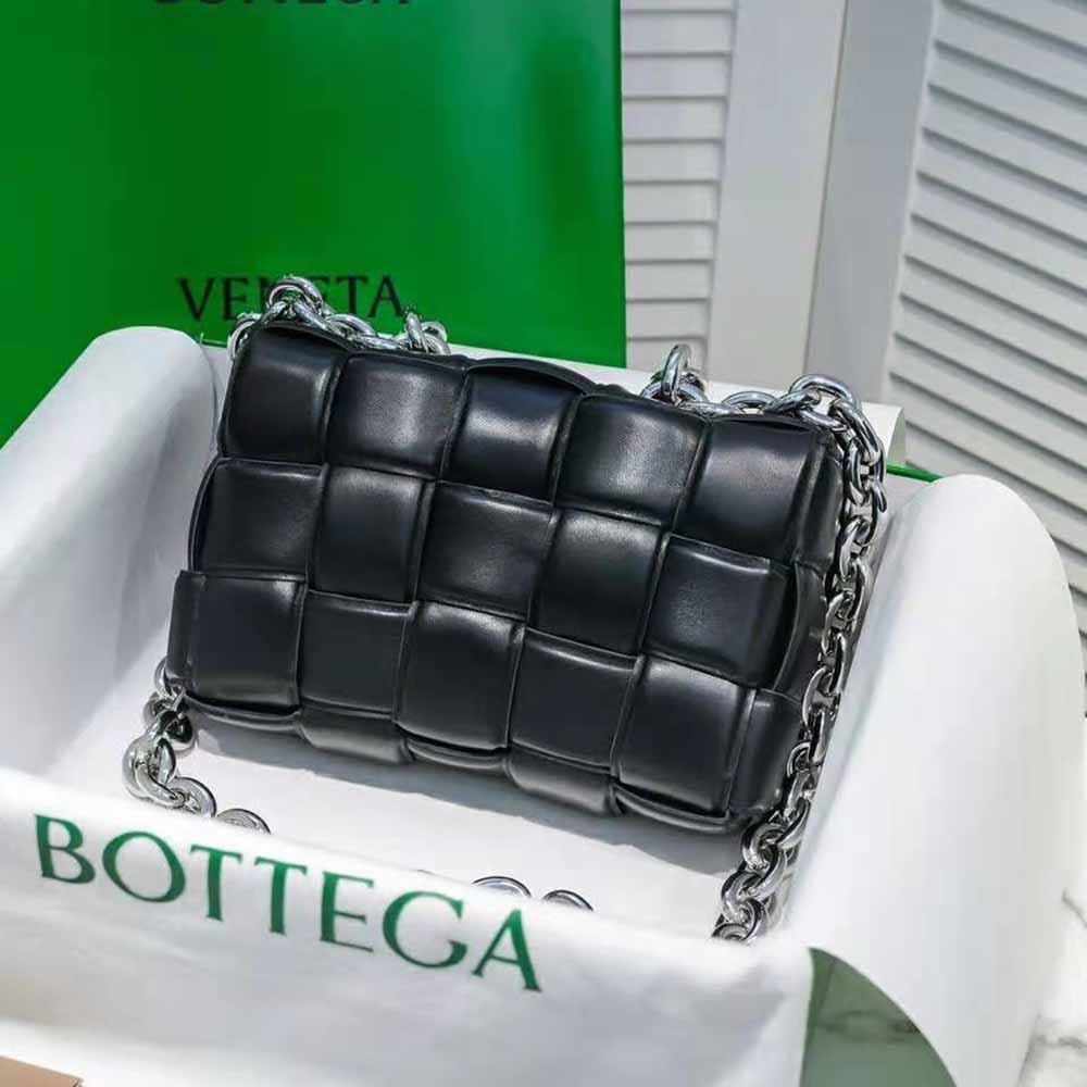 Side angle showing silver-tone chain and flap closure of Bottega Veneta crossbody