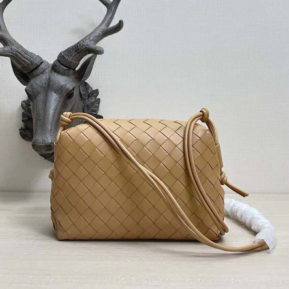Side angle showing silver-tone hardware on Bottega Veneta brown leather bag