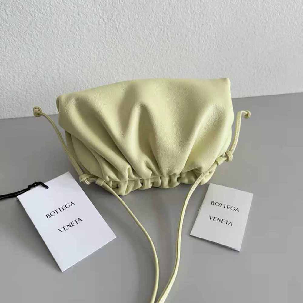 Side profile showing strap and compact silhouette of Bottega Veneta mini leather clutch