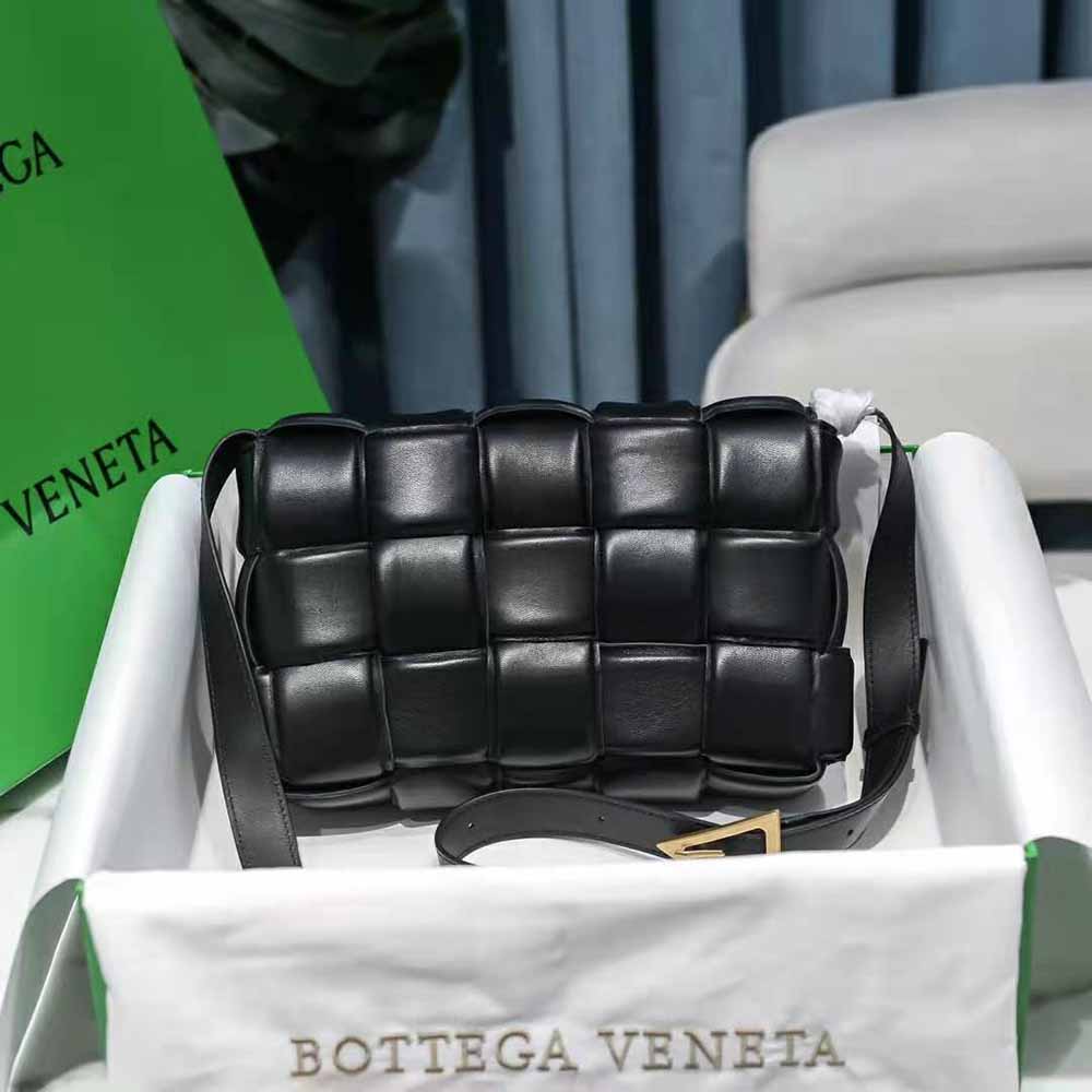 Side profile showing gold-tone closure on Bottega Veneta Padded Cassette cross-body bag