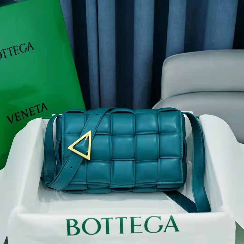 Close-up of blue intreccio leather texture on Bottega Veneta padded cross-body bag