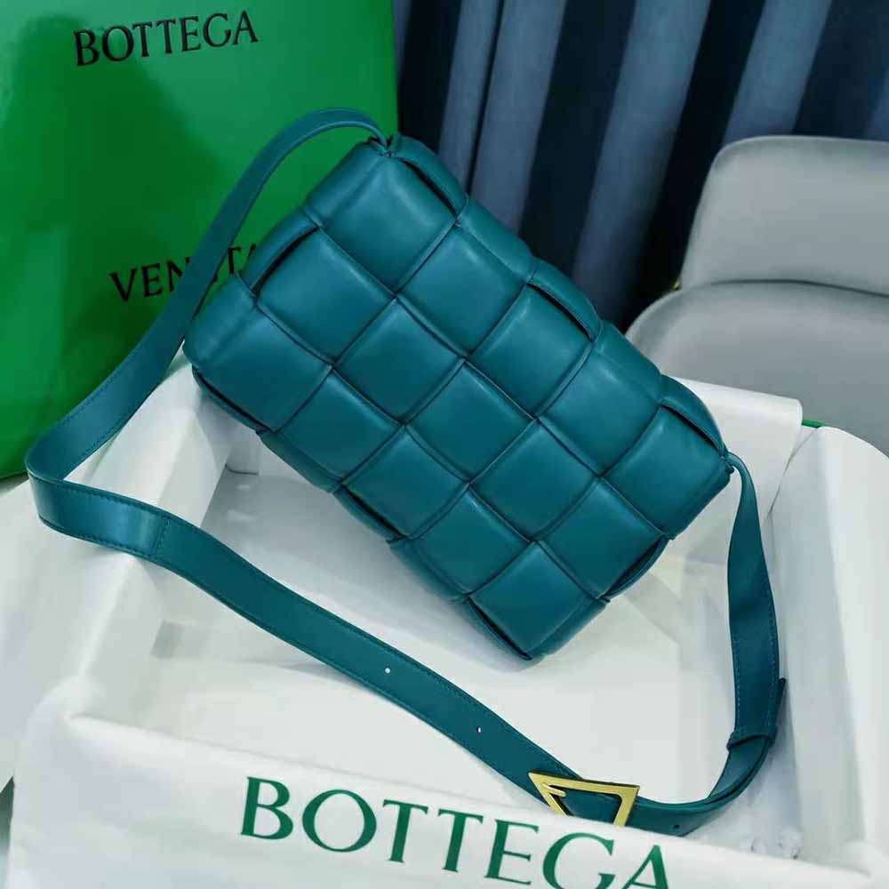 Side angle showing silver hardware and flap closure of Bottega Veneta blue shoulder bag