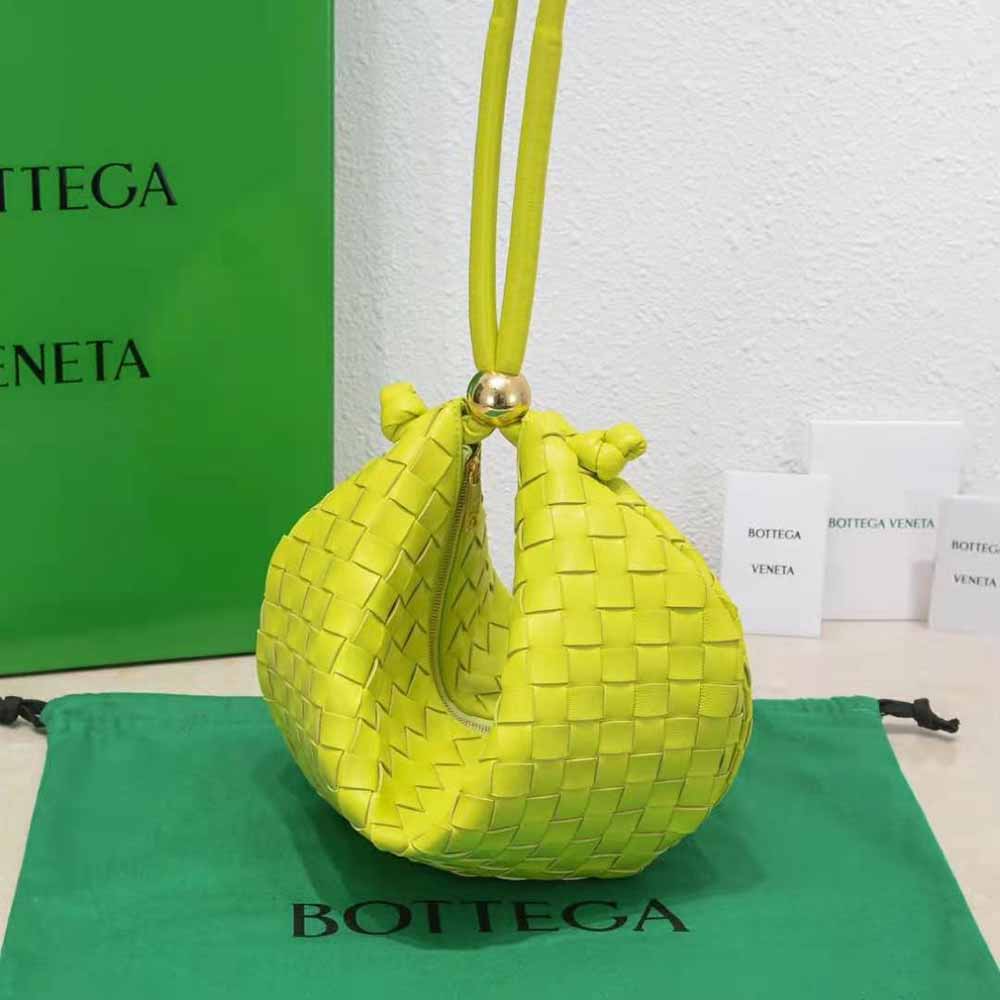 Side angle showing adjustable strap and gold hardware on Bottega Veneta pouch