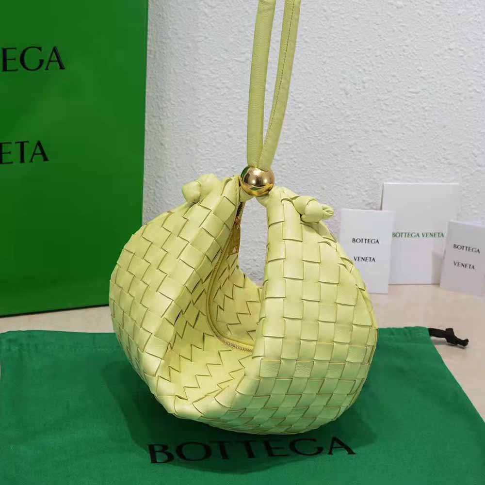 Side angle showing adjustable strap on Bottega Veneta yellow leather pouch