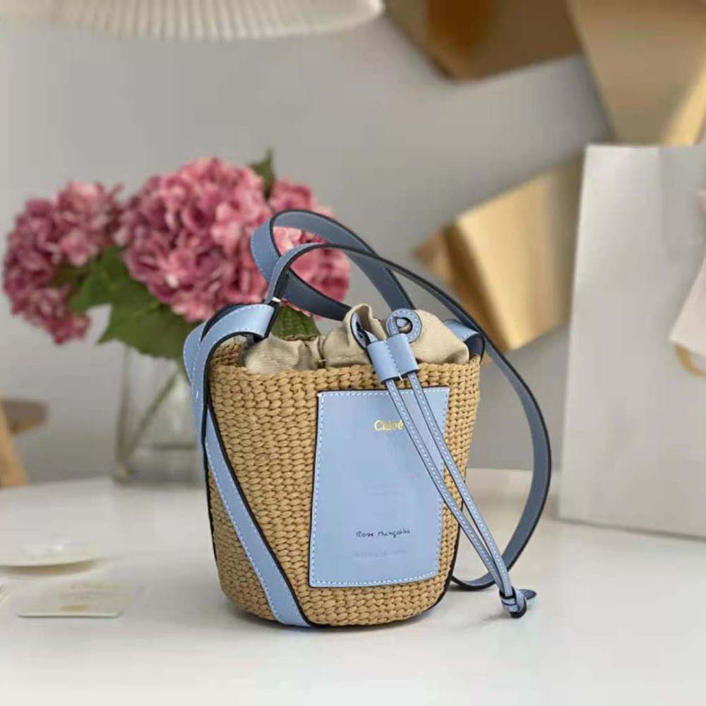 Side angle highlighting woven paper texture on Chloe Women Small Basket in blue