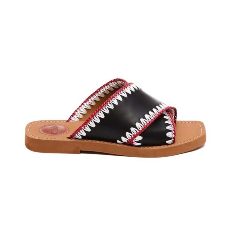 Side profile of Chloe Women Woody Flat Slide-Black showing wooden sole