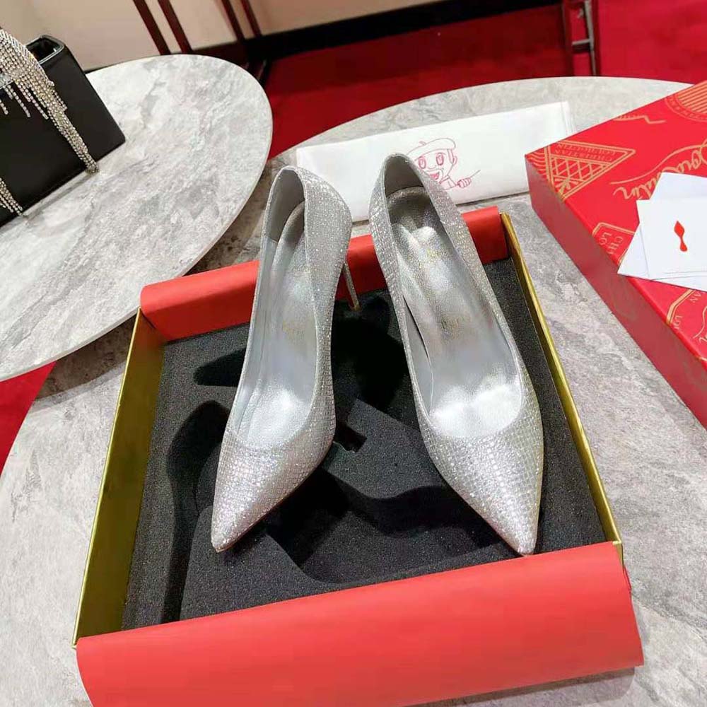 Close-up of silver patent leather and red sole detail