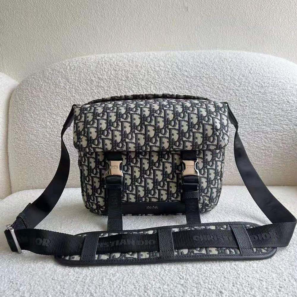 Close-up detail of black leather trim and silver hardware on Dior Men Explorer Messenger Bag