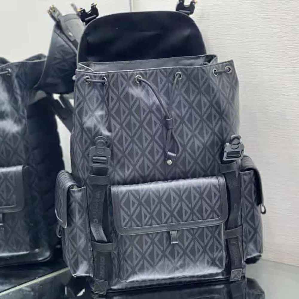 Side profile showing zip closure and leather trim on Dior Men Hit the Road Backpack