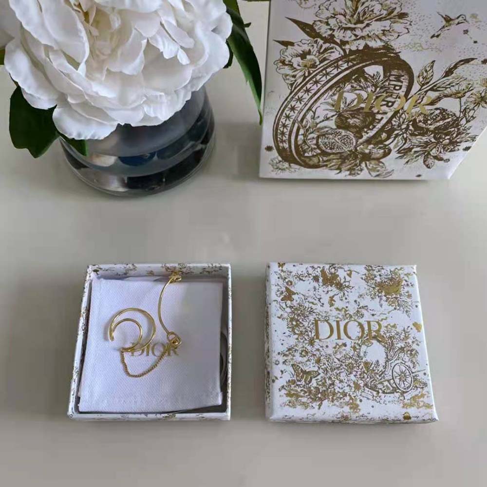 Close-up detail of Dior emblem on 30 Montaigne Ear Jewelry gold finish