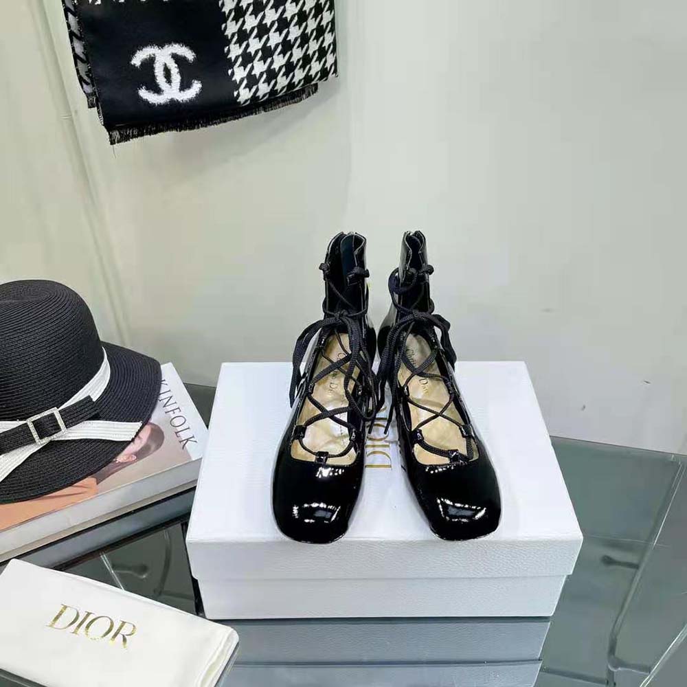 Close-up on lace-up front and patent leather texture of Dior boot