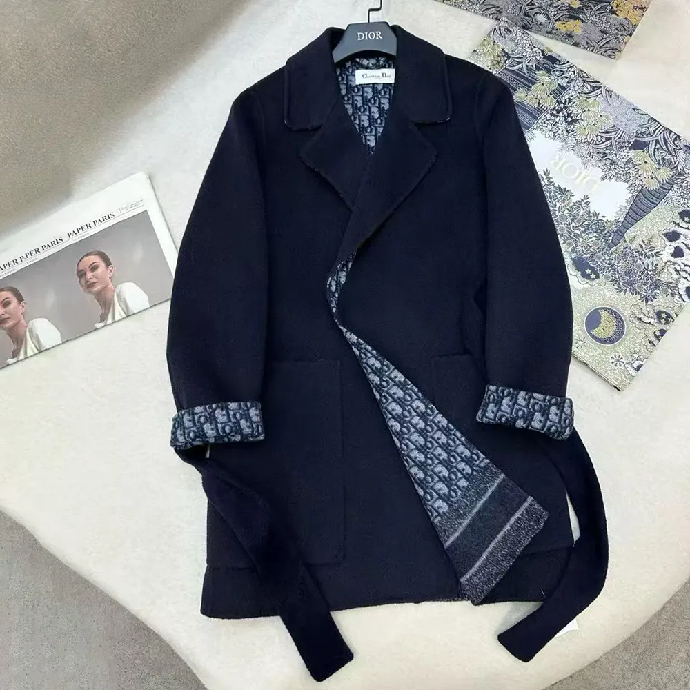 Close-up of signature Dior buttons on blue wool coat
