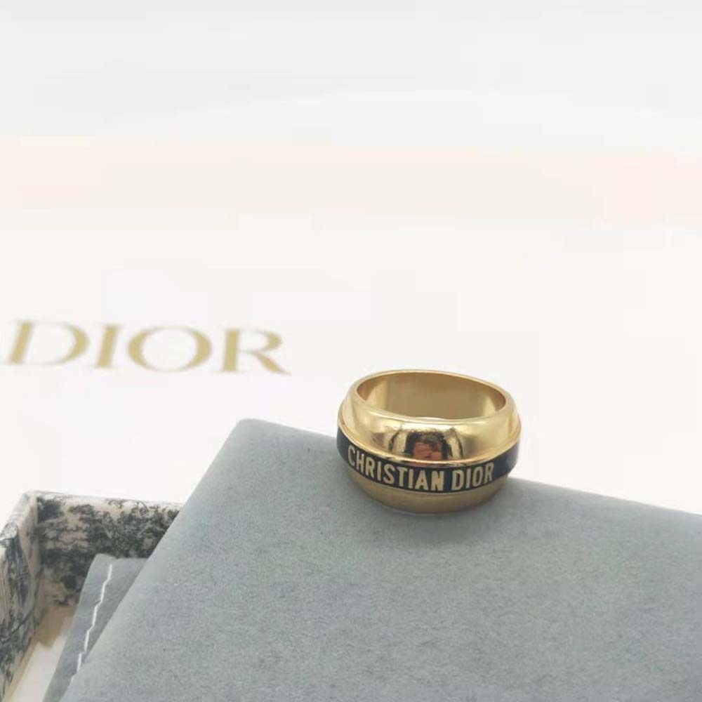 Side profile showing gold-finish and black lacquer details on Dior ring