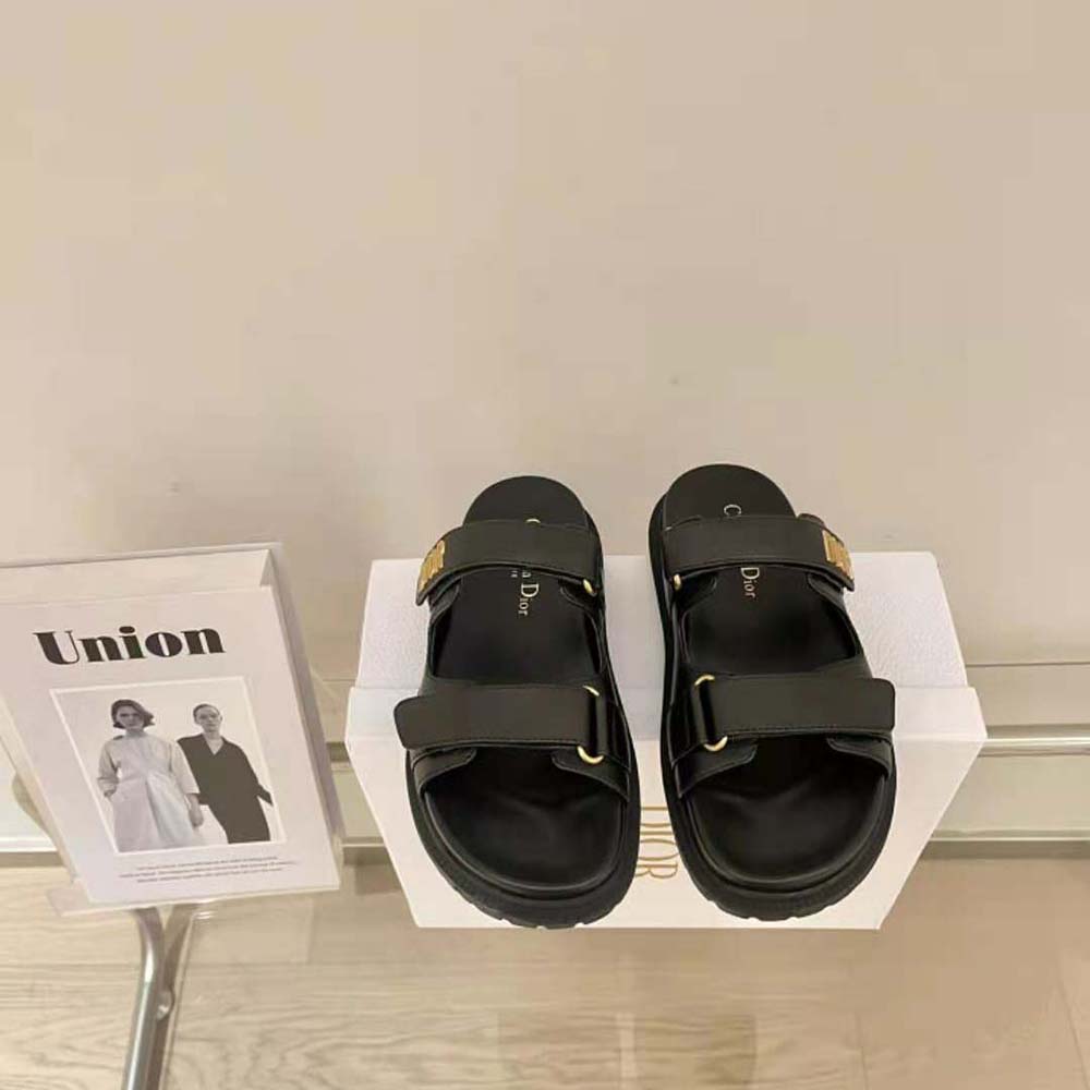 Close-up of gold Dior hardware detail on DiorAct Slide sandal