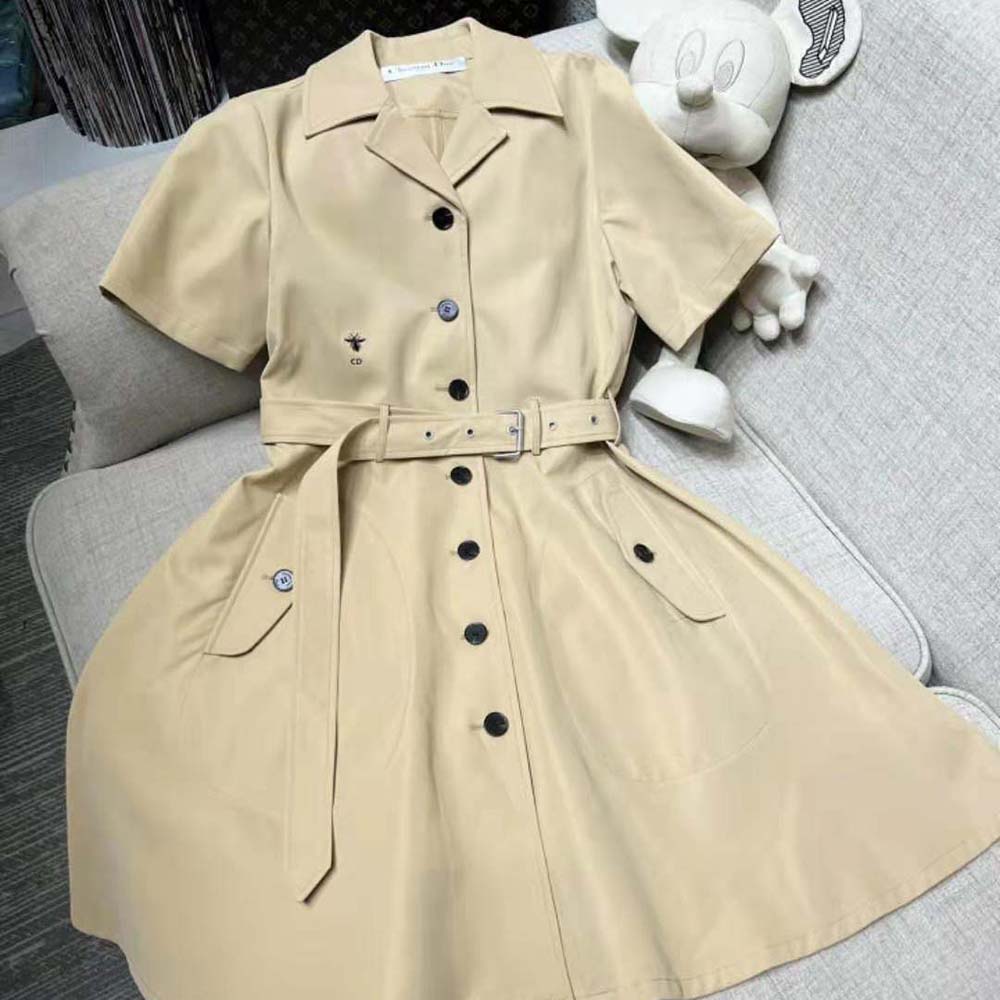 Close-up of belt and Dior signature hardware on beige dress