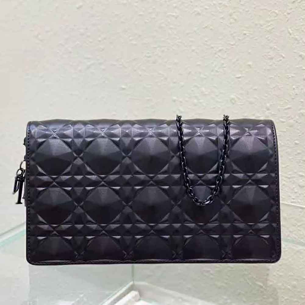 Close-up of diamond motif and Cannage texture on Lady Dior Pouch black leather