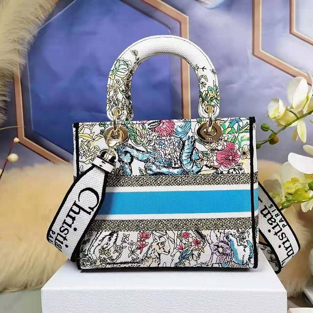 Side angle showing silver hardware and structured silhouette of Dior Women Medium Lady D-Lite Bag
