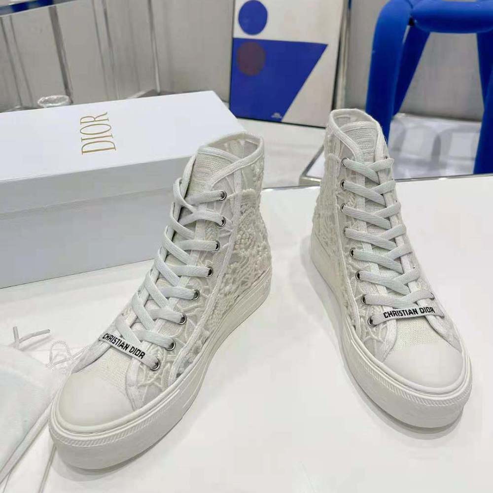Top-down look at lace-up and Dior branding on white high-top sneaker