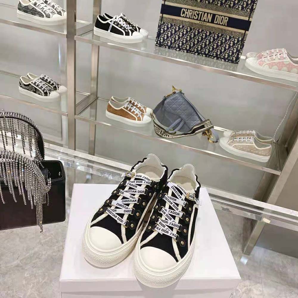 Close-up of silver Dior hardware on sneaker lace eyelets