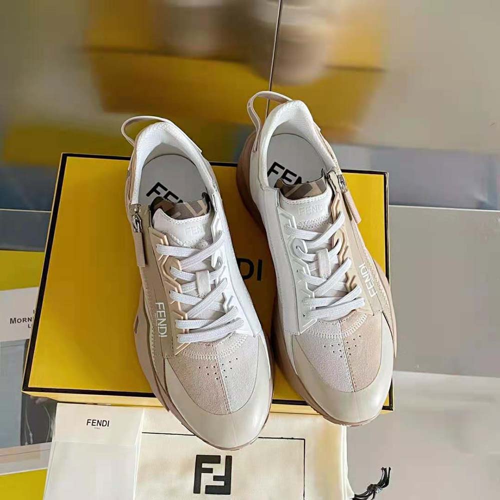 Close-up on embossed Fendi logo detail on beige suede sneakers
