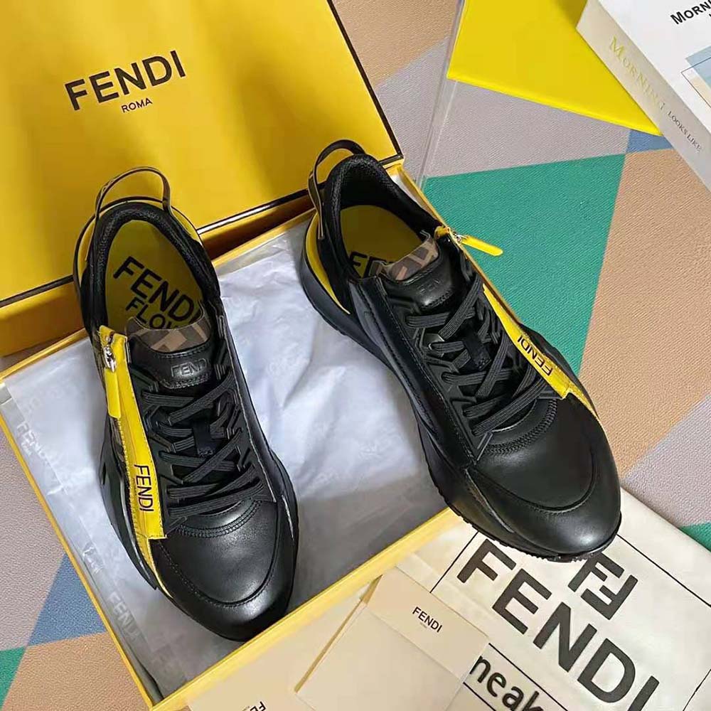 Close-up detail of embossed Fendi logo on black leather low-tops