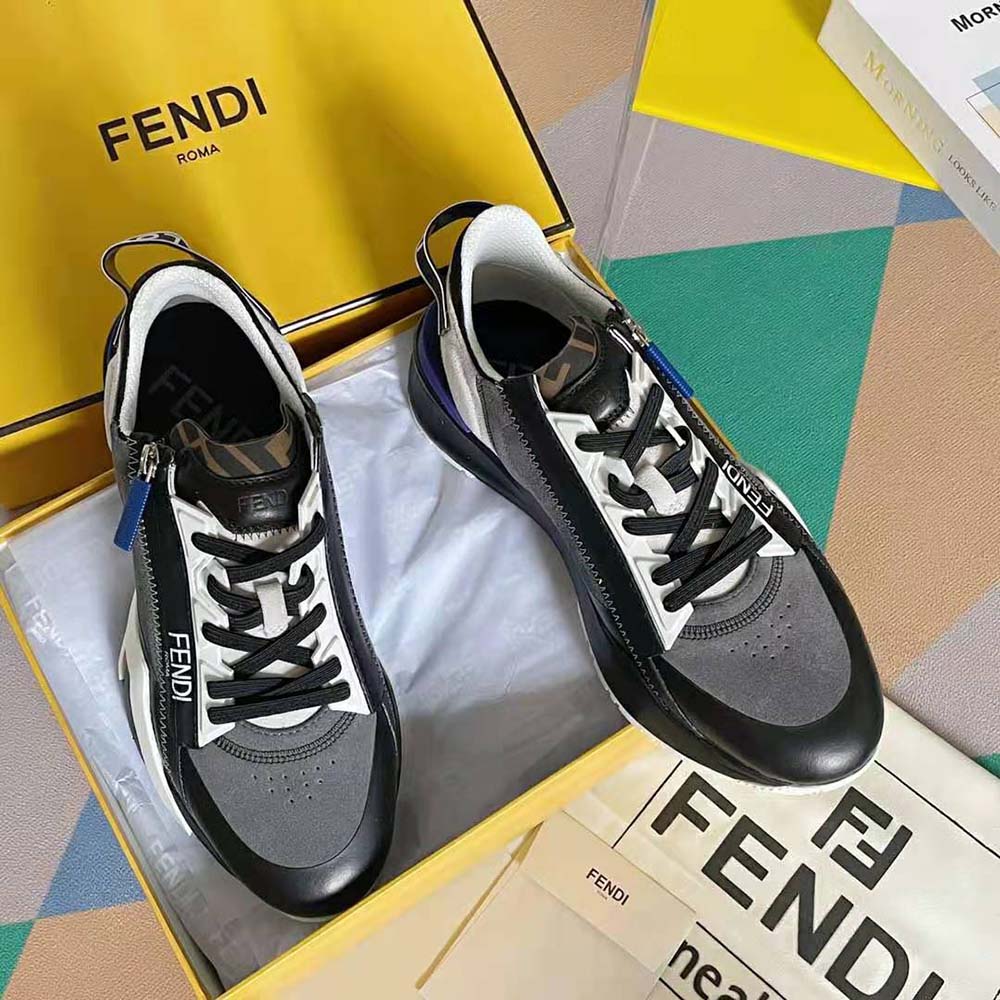 Close-up of navy suede and Fendi logo hardware on low-tops