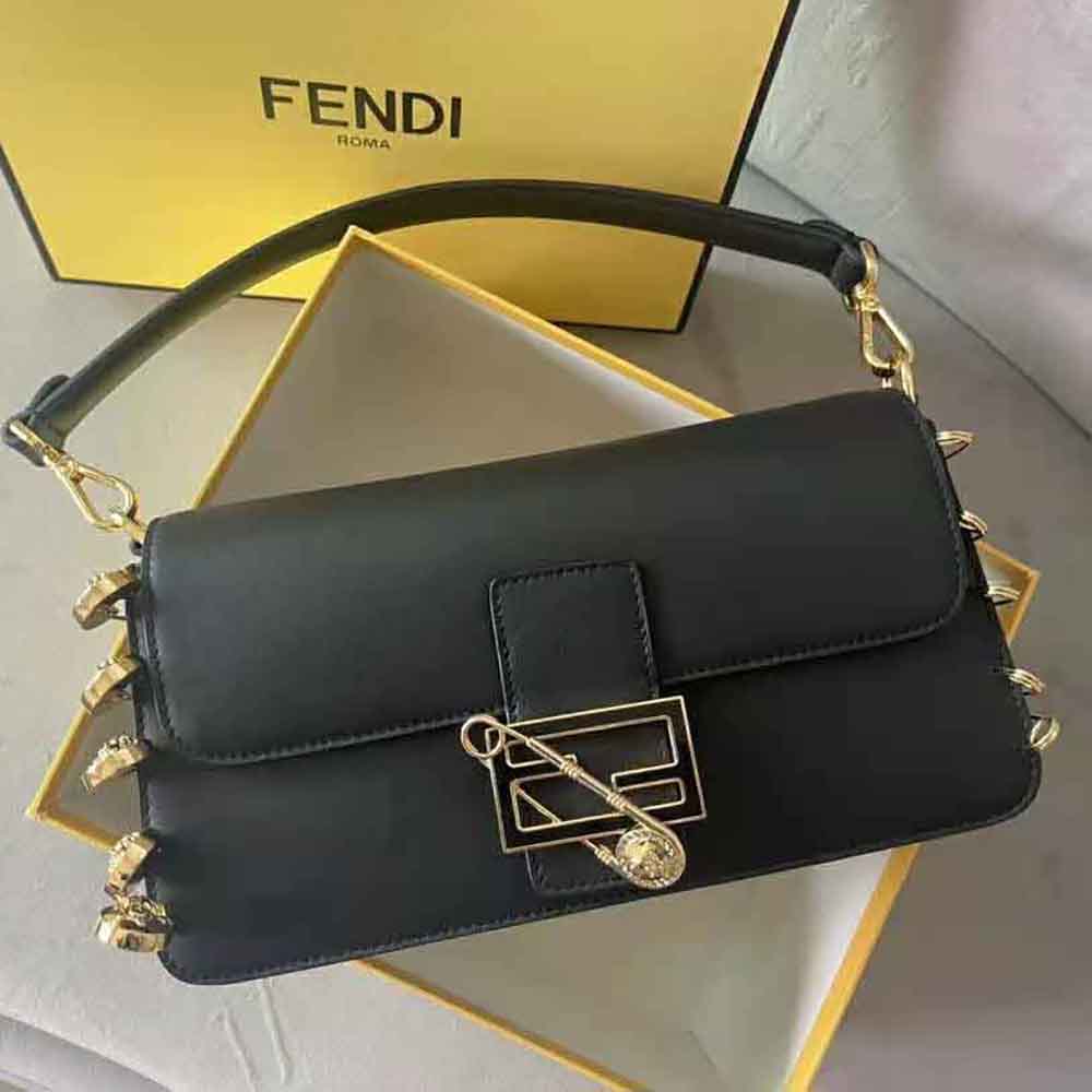 Close-up of gold brooch clasp on Fendi Women Baguette Brooch Fendace Black Leather Bag