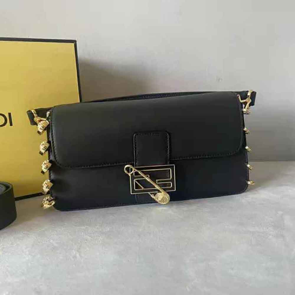Side angle showing compact silhouette of Fendi Women Baguette Brooch Fendace Black Leather Bag
