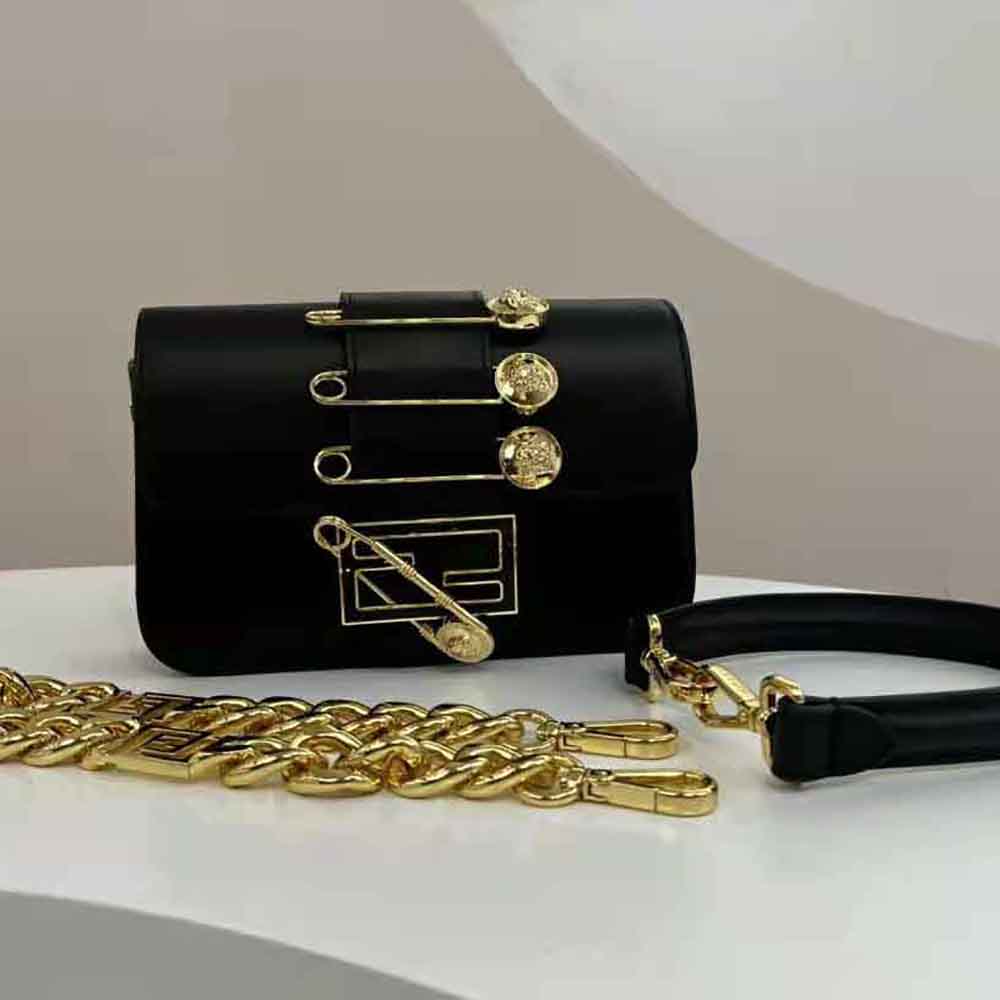 Close-up of gold-tone brooch detail on Fendi Women Brooch Mini Baguette