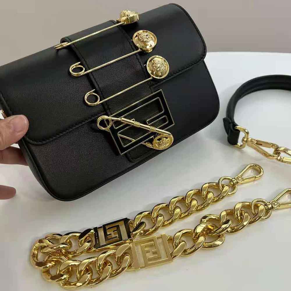 Side view showing compact silhouette of Fendi Women Brooch Mini Baguette Black Leather