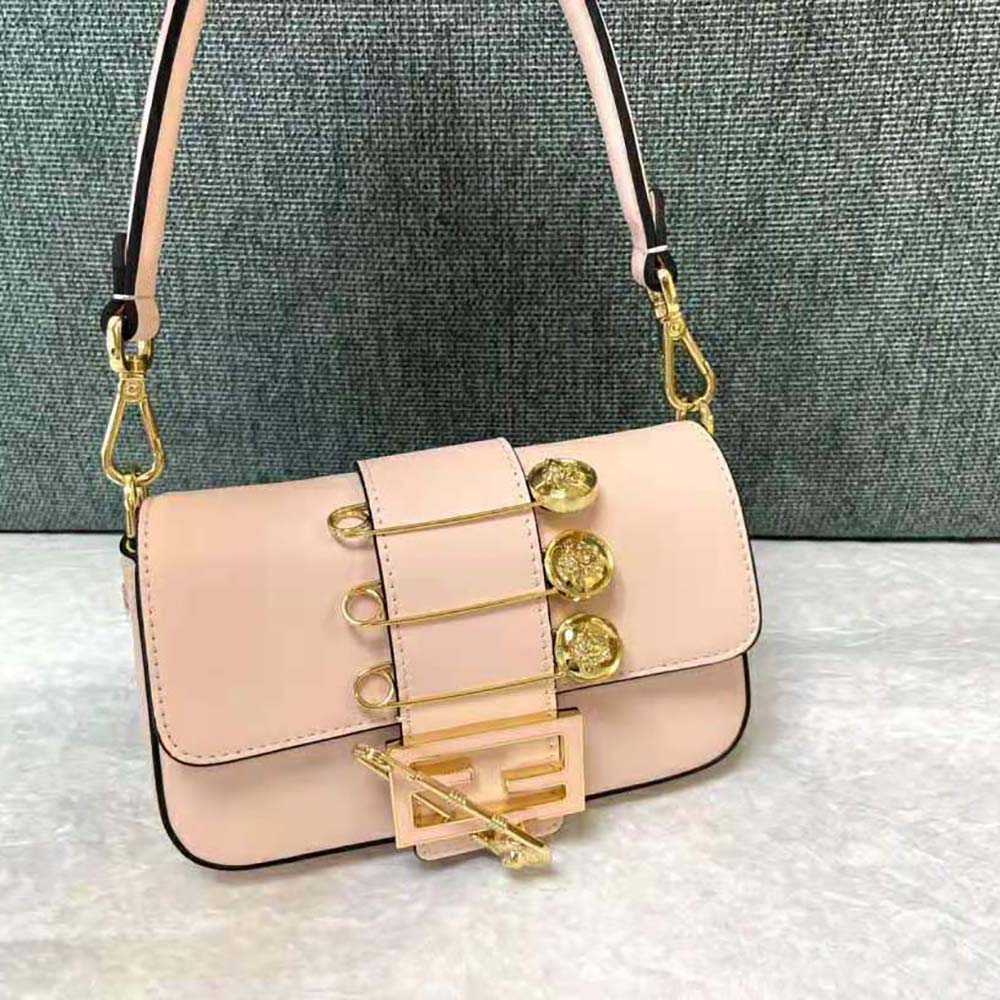 Side angle showing compact silhouette of Fendi Women Brooch Mini Baguette Bag