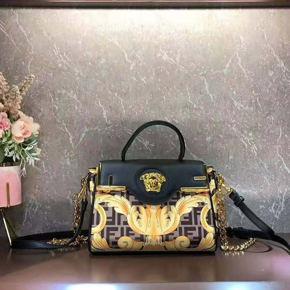 Close-up of gold-tone Medusa head hardware on Fendi Women Fendace La Medusa Medium Handbag-Black