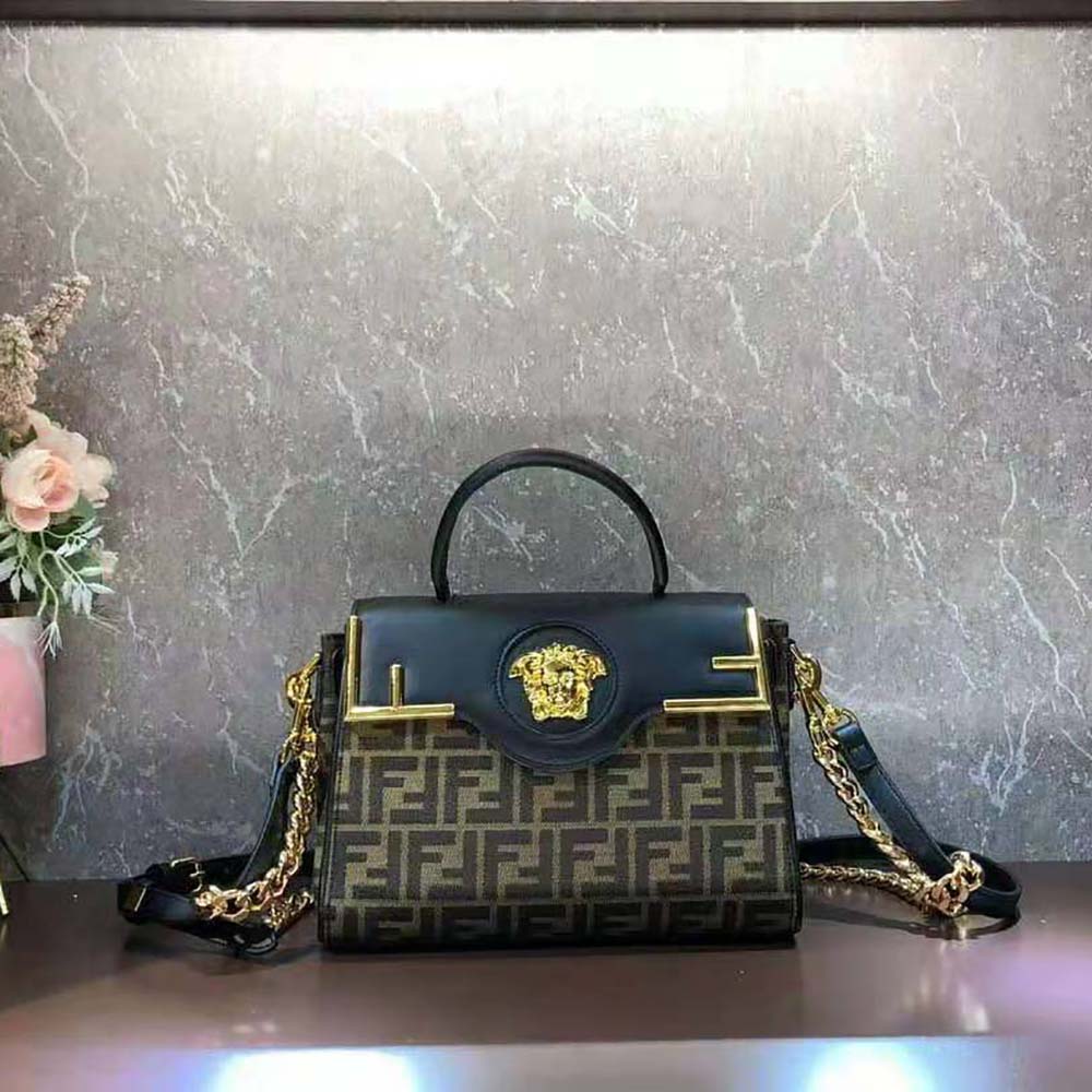 Close-up of gold Medusa head clasp on Fendi Women Fendace handbag