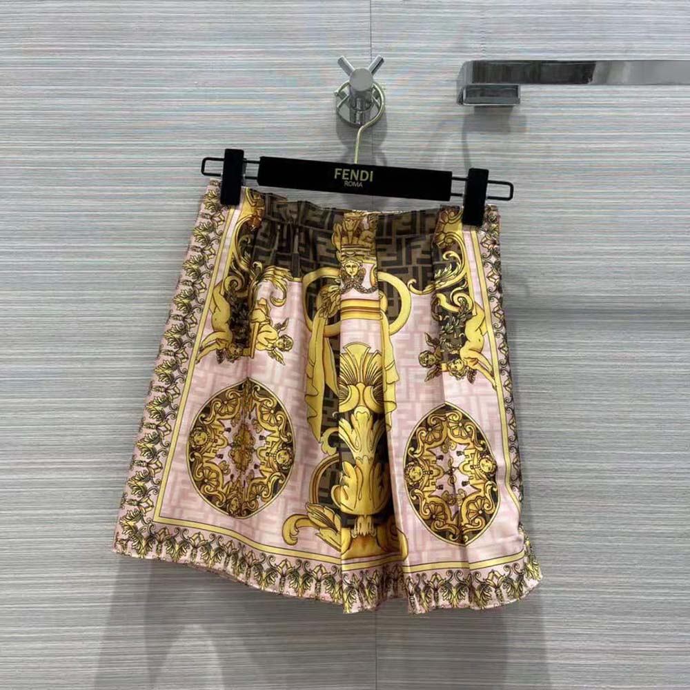 Close-up detail of signature Fendace hardware on silk skirt
