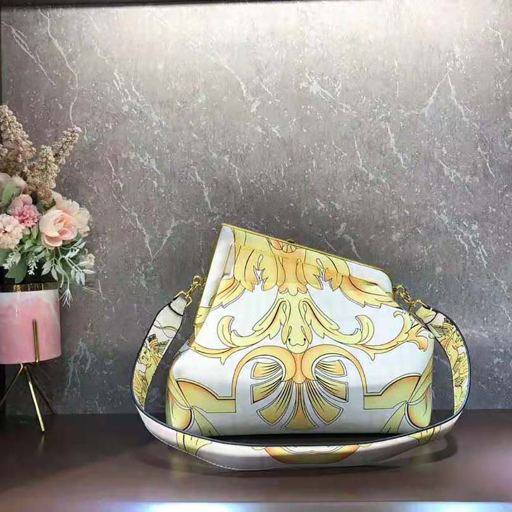 Side angle showing yellow print and flap closure on Fendi bag