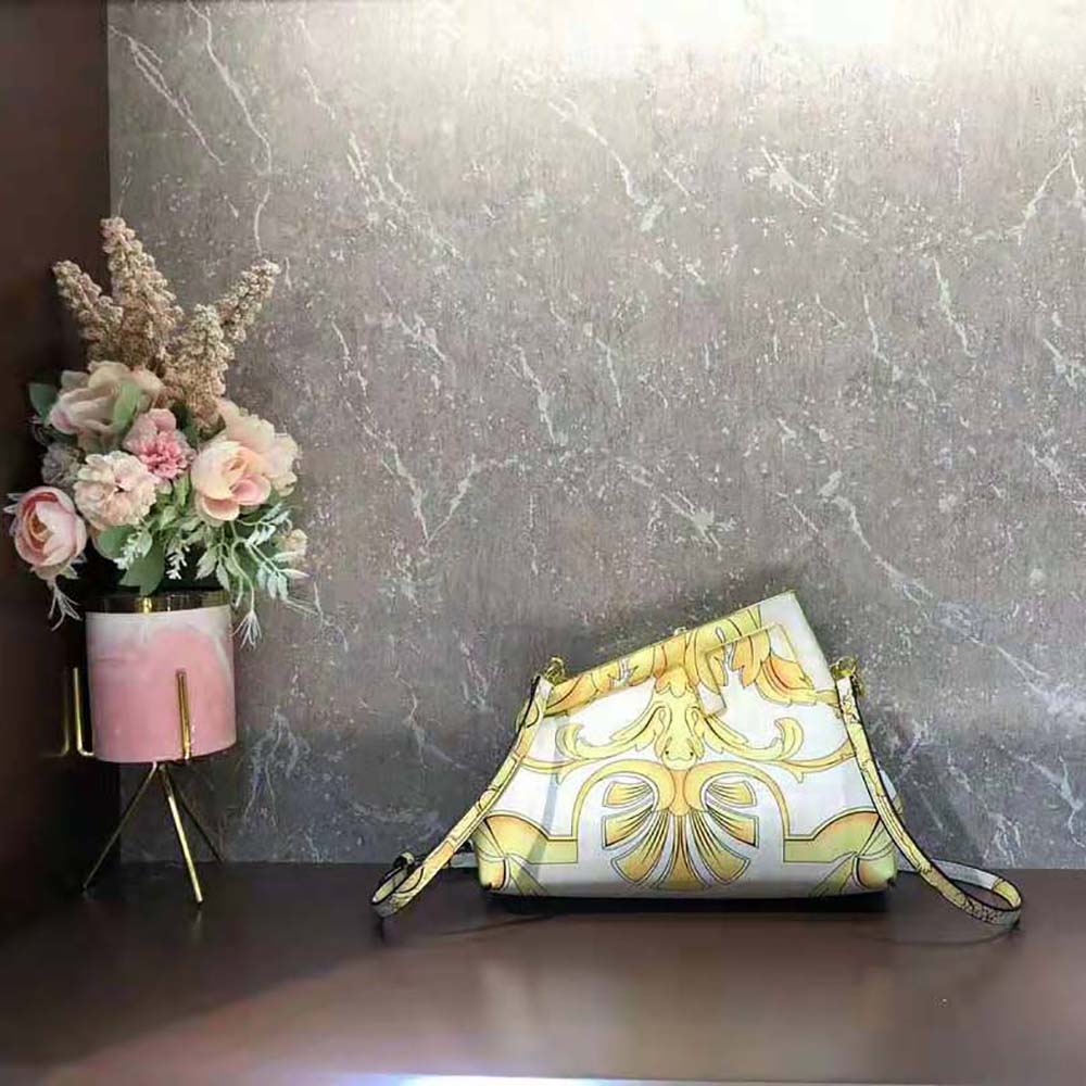Close-up of gold-tone hardware and signature Fendace print on silk bag