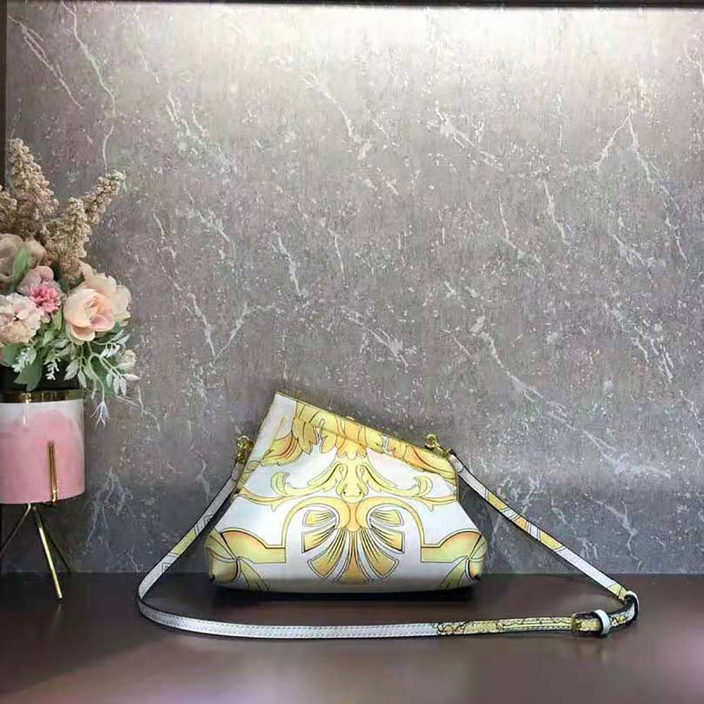 Side angle showing adjustable strap and compact silhouette of Fendi silk bag