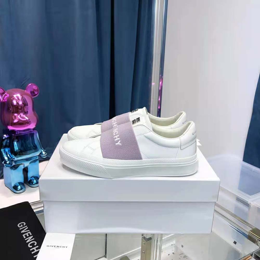 Close-up of purple leather and GIVENCHY webbing strap detail on sneakers