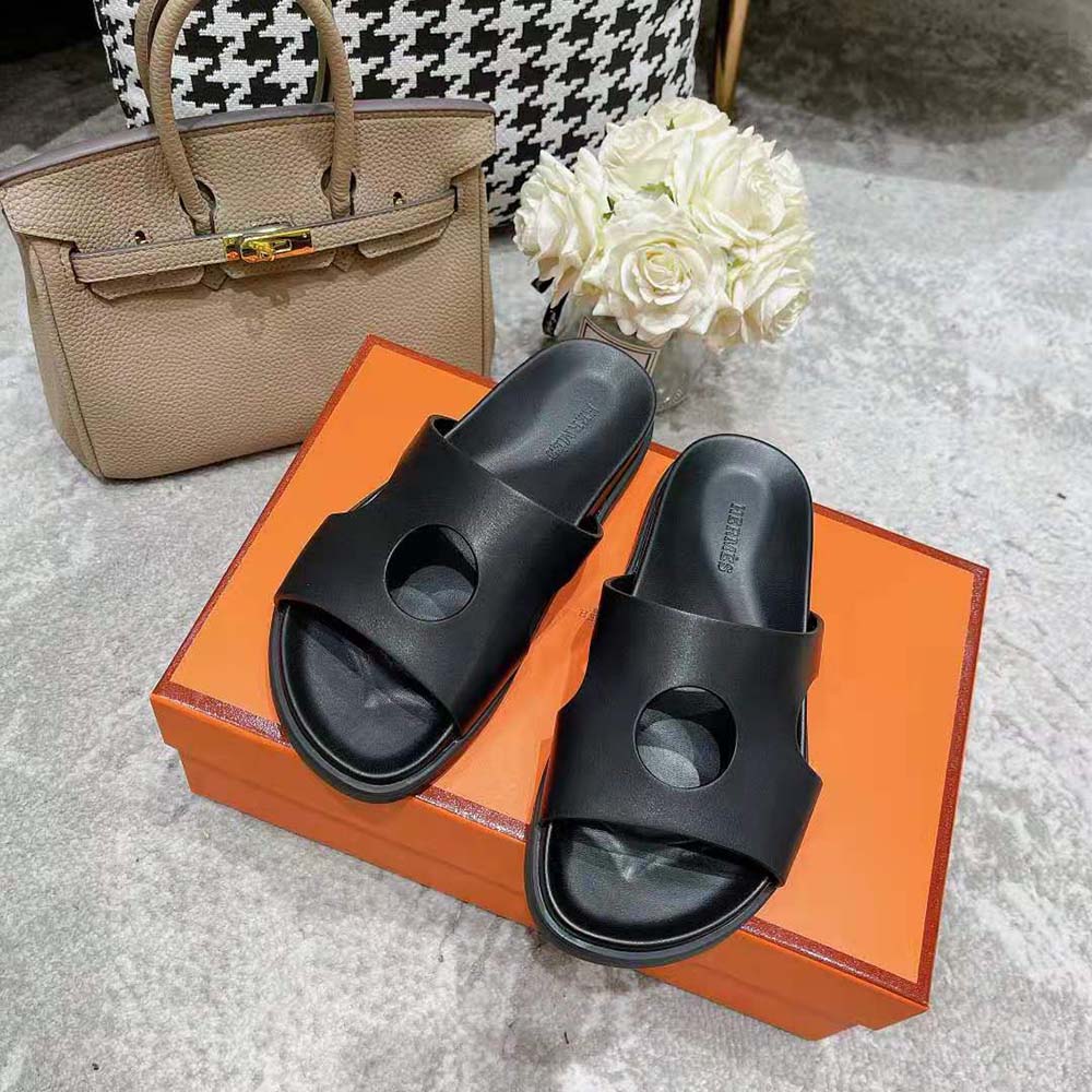 Close-up of perforated black calfskin upper on Hermes Women Edith Sandal