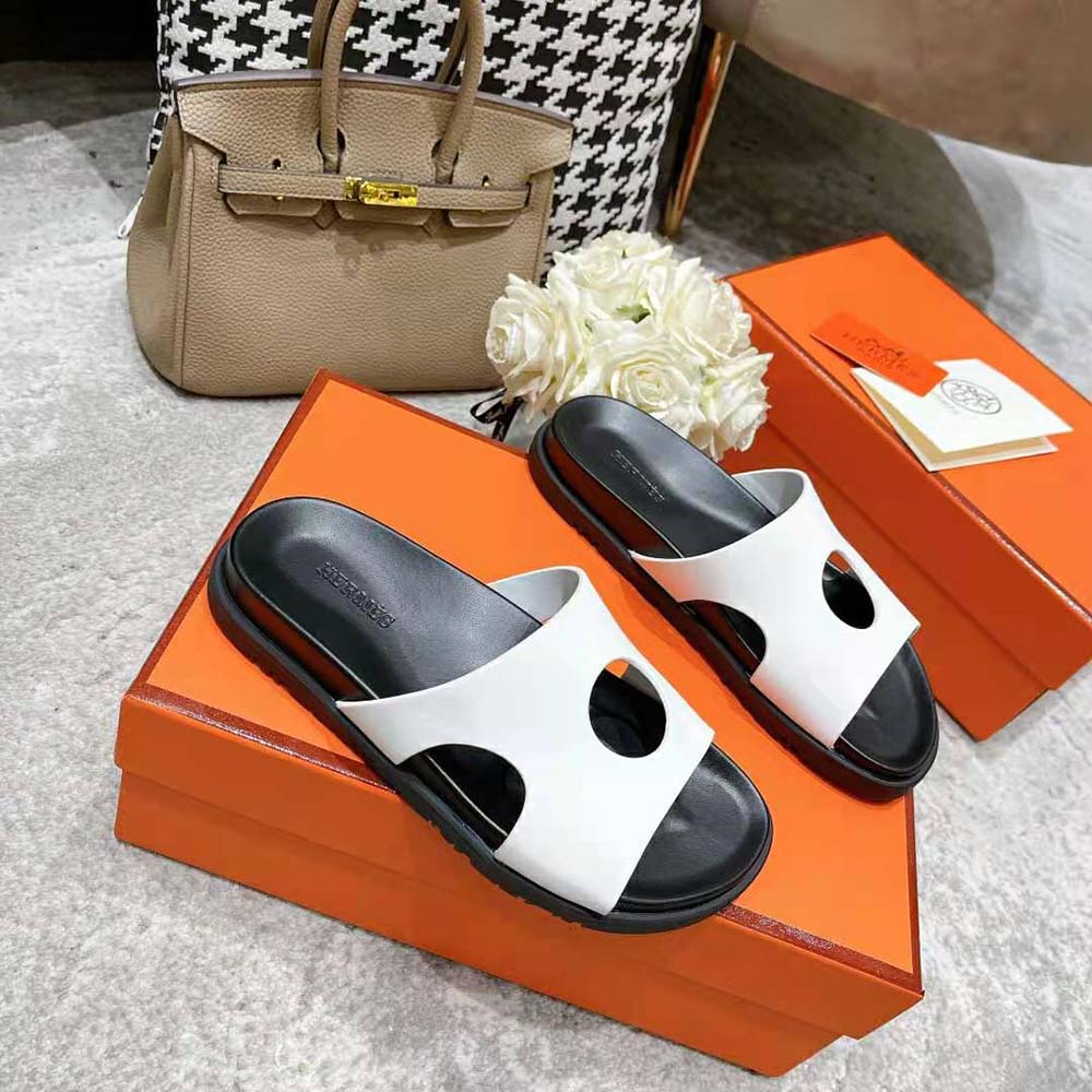 Close-up detail of perforated white calfskin on Hermes Women Edith Sandal