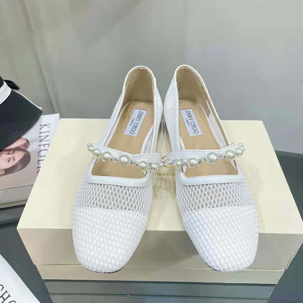 Top-down look at white fishnet mesh and latte nappa leather flats from Jimmy Choo