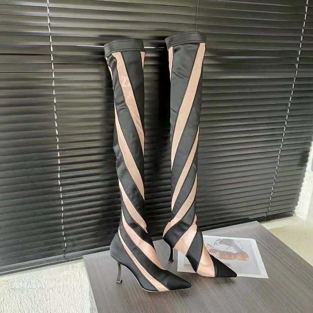 Close-up detail of sheer spiral stretch fabric on Jimmy Choo boots