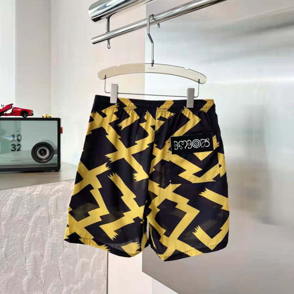 Close-up of allover print and branded leather tab on Loewe shorts