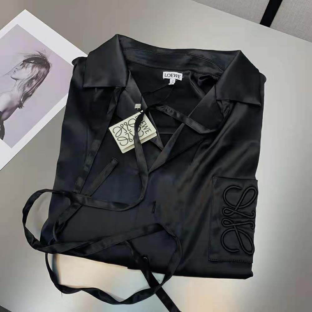 Close-up detail of embroidered Anagram on Loewe Satin-Black blouse