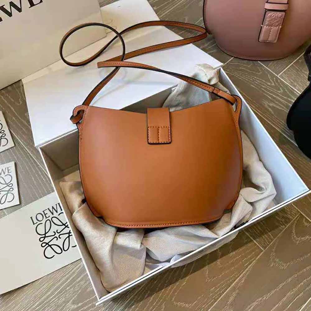 Side angle showing silhouette and shoulder strap of Loewe Women Moulded Bucket Bag