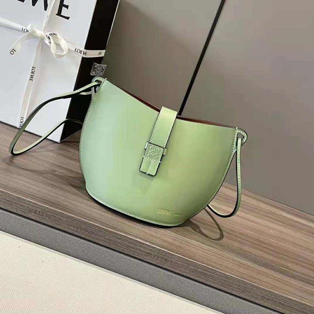 Close-up of magnetic closure and silver hardware on Loewe bucket bag