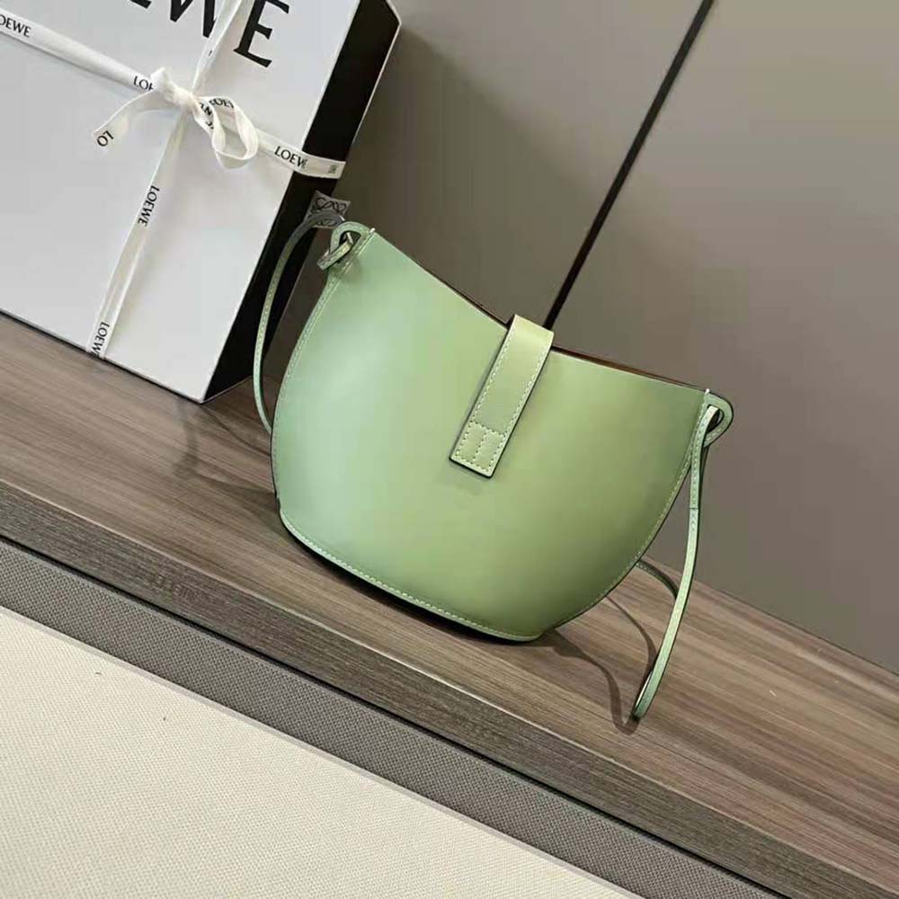 Side profile showing structured lime calfskin silhouette of Loewe bag