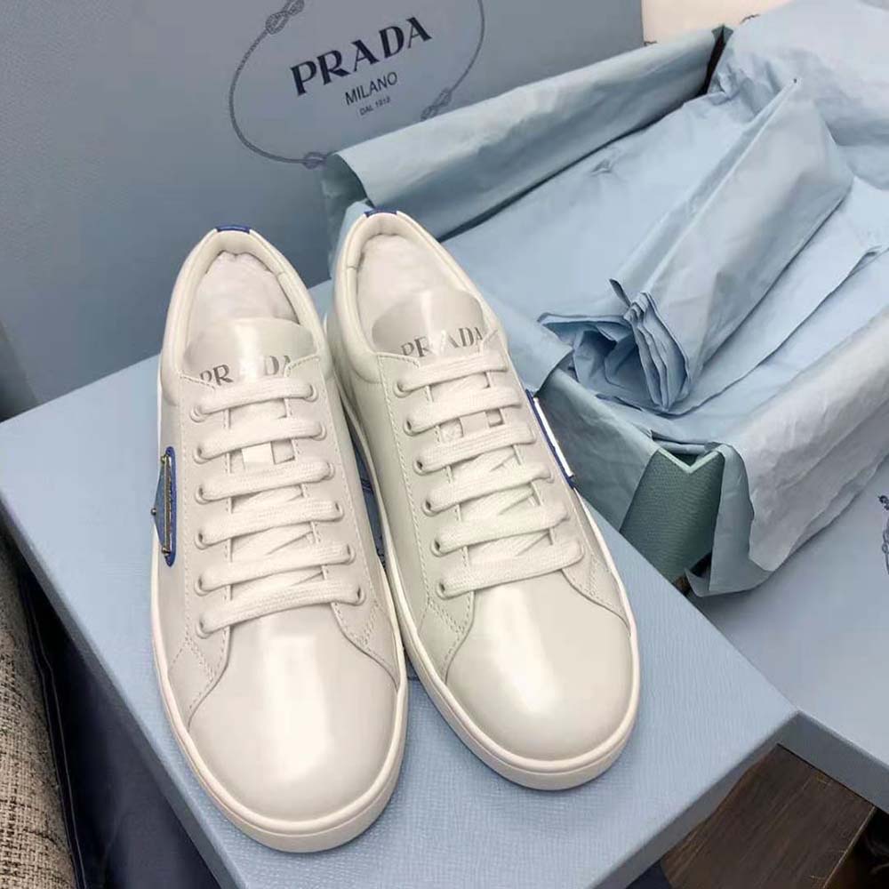 Close-up detail of brushed leather and Prada logo on sneakers